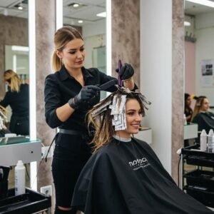 Hair highlighting service in a modern salon setting with a stylist and client