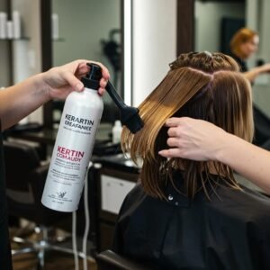 Professional stylist applying keratin treatment in a modern salon, highlighting hair repair and beauty